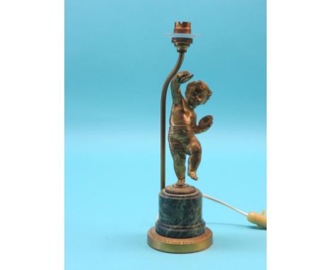 An ormolu table lamp, semi-nude youth with symbols, on simulated malachite plinth, 11in.