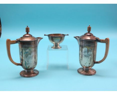 An Art Deco silver three-piece coffee set, two coffee pots, each with wood handle and finial, and pedestal sugar bowl, Sheffi