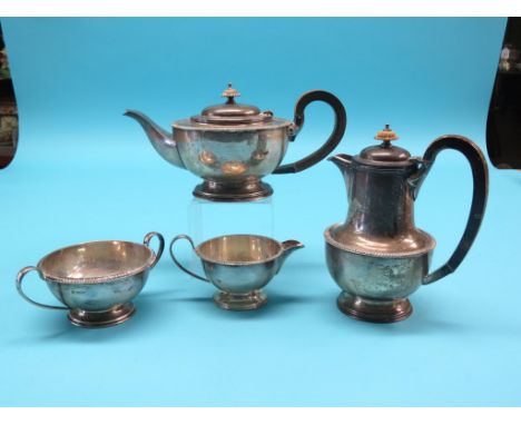 A silver four-piece teaset, teapot and hot water jug with wood handles, two-handled sugar bowl and milk jug, cast borders, Sh