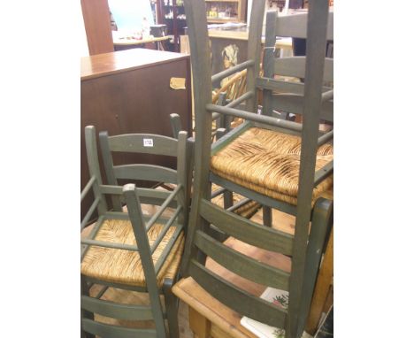 A set of six green-stained beech dining chairs, ladder-backs and rush seats 