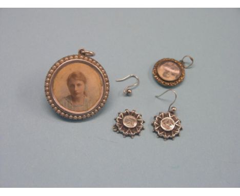An early 20th century white metal locket, with seed-pearl circumference, twin inset portrait photographs, a smaller yellow me