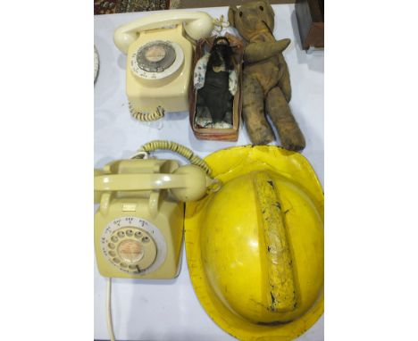 A Devon Fire Brigade helmet, an embroidered silk kimono style dressing gown, various dolls, teddy bears and other items.