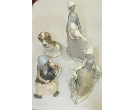 A Lladro figure,  girl with goose and puppy, two others, girl with a turkey and girl with a dove and a Nao figure, (4).