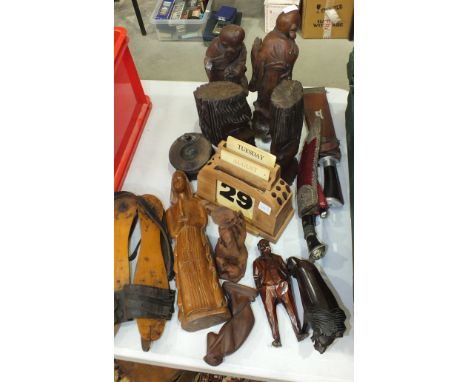 A pair of vintage wood frame ice skates, a kukri knife in white metal mount, various carved wood figures and other items.