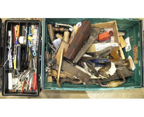 A collection of woodworking and other tools, including planes and brace and bit.