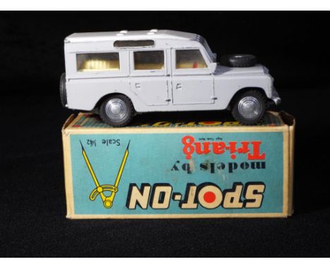 Triang Spot-On - A boxed Triang Spot-On 161 LWB Land Rover. The model has a light grey body, white roof, with cream interior 