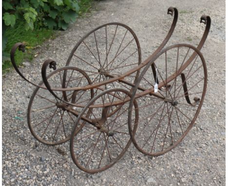 A vintage wrought-metal pram/perambulator base, 46” wide.