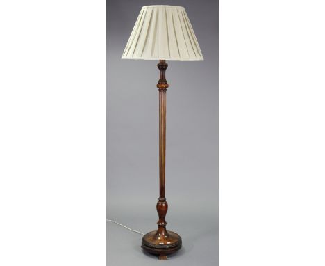 A beech standard lamp having vase-turned &amp; fluted centre column, &amp; on a round stepped base, with shade.
