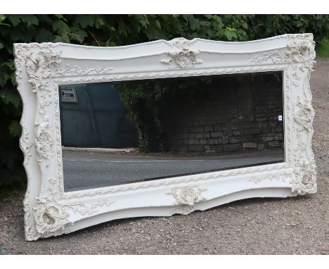 A continental-style large rectangular wall mirror inset bevelled plate, &amp; in a white-finish composition frame with pierce