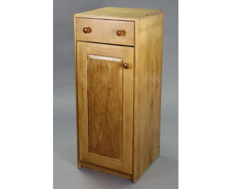 A light elm upright cupboard fitted frieze drawer above two shelves enclosed by a panel door, 17¾” wide x 44” high x 17¾” dee