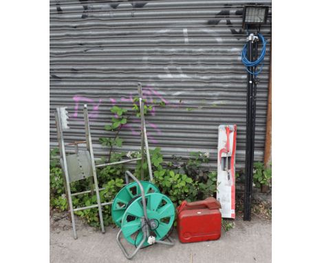 A halogen lamp with tripod; together with a saw-horse; a wallpaper paster; a tile-cutter; a cable reel; &amp; a petrol can. 