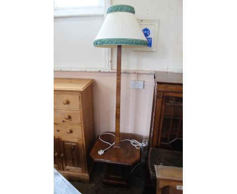 A 1930's walnut veneered standard lamp with shelf