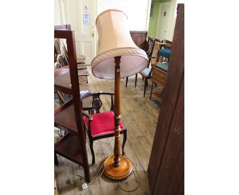 A modern carved walnut standard lamp