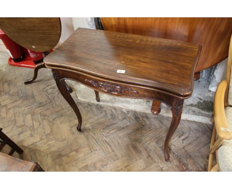 A Victorian carved walnut card table