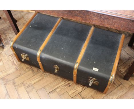 A vintage bentwood and canvas steamer travelling trunk