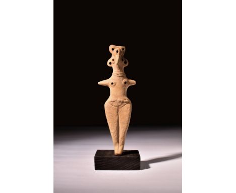 Ca. 2000-1000 BC.A pottery figure in buff colour depicting Astarte. The figure has bird-like facial features with big round e