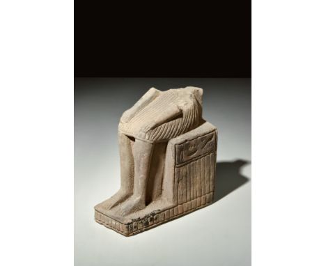 New Kingdom, Ca. 1550-1069 BC.A stone statue of a seated figure, comprising an L-shaped base with decorative vertical striati