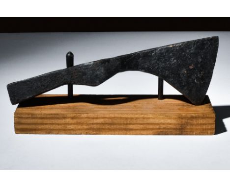 Ca. 900-1100 AD.An iron axe head rendered with a curved cutting edge for versatile use. The piece was likely found in a settl