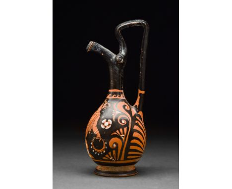 Ca. 400 BC.An Apulian red-figure epichysis presenting a pear-shaped lower body which merges into a tubular neck and a finely 