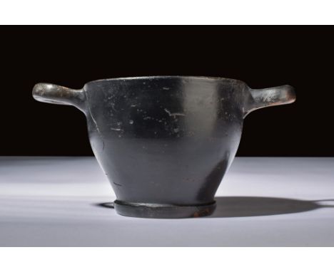 Ca. 350 BC.A black-glazed skyphos with deep, curved sides, two loop handles, and a smooth surface. The shape is characteristi