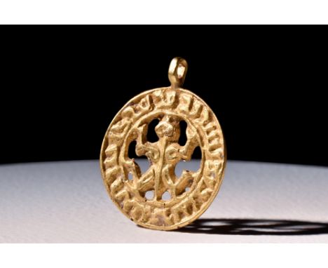 Ca. 900 AD.A gold pendant with calligraphy around the edge and an intricate openwork frog in the centre. It comes from 9th-ce