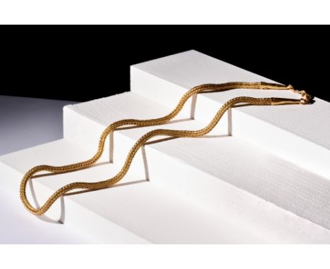 Ca. 100-300 AD.A gold chain made with flawless round links. It has finely crafted finials with conical-shaped tubes on the en
