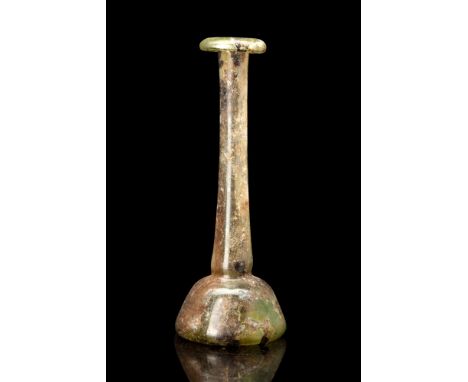 Ca. 100-200 AD.A green glass candlestick unguentarium with a bell-shaped lower body, rounded shoulder, thin, elongated neck, 