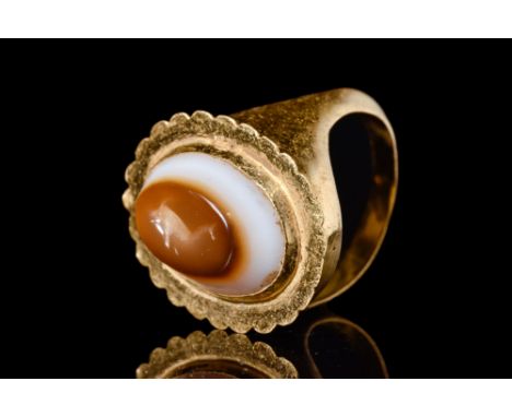Ca. 100-200 AD.A gold ring characterised by its distinctive gold setting. The substantial bezel features a banded agate intag