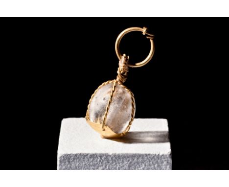 Ca. 900-1100 AD.A Viking rock cyrstal bead in possibly later high carat gold setting, comprised of woven, cage-like golden wi