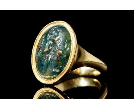 Ca. 100-300 AD.A gold ring featuring an oval bloodstone with an intaglio of Victory, a figurative symbol portraying Roman mil
