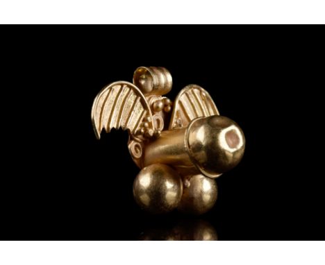 Ca. 100-200 AD.A gold pendant displaying a winged phallus, intricately crafted with filigree and granule details. Above this 