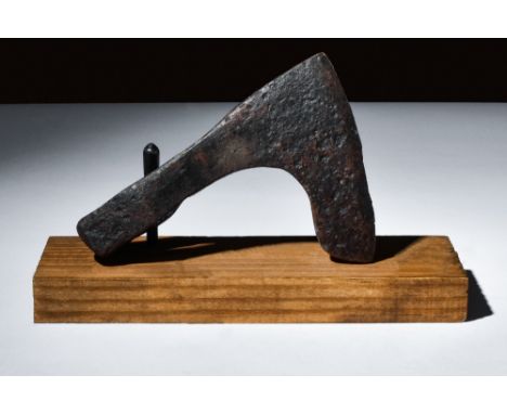 Ca. 900-1100 AD.An iron axe head with a bearded design and a curved cutting edge, enabling efficient chopping and cutting. It