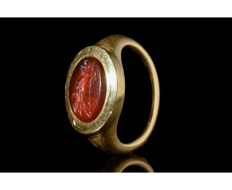 Ca. 100-200 AD.An oval carnelian intaglio depicting Mars, the Roman god of war, holding a spear and shield. For similar see: 