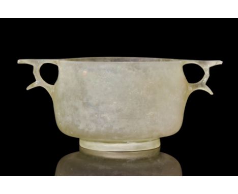 Ca. 100-200 BC.A pale yellow-green in color, cast, lathe-cut and polished, the hemispherical body on an outsplayed ring foot,
