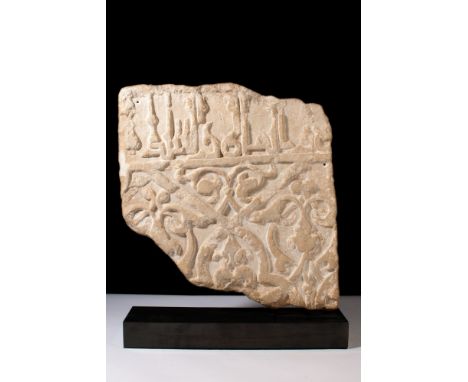 Ca. Early 1200 AD.A marble dado panel displaying Kufic script along its upper edge. The central register features tri-lobed l