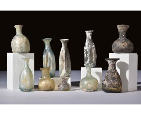 Ca. 100-300 AD.A set of 10 distinctly shaped glass vessels used to store perfumed oil, or unguents. The shapes in this lot va