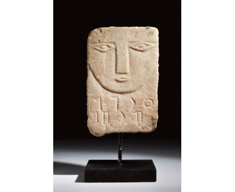 Ca. 200 BC-200 AD.An alabaster funerary stele bearing a stylised low-relief depiction of the deceased's face, emphasising the