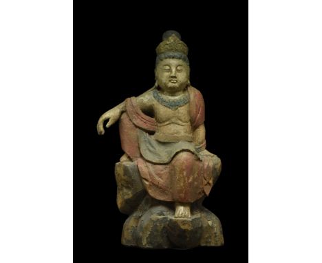 Ca. 1368-1644 AD. A polychrome painted wooden figure of Bodhisattva. He is depicted sat atop rocks in rajalilasana, a positio