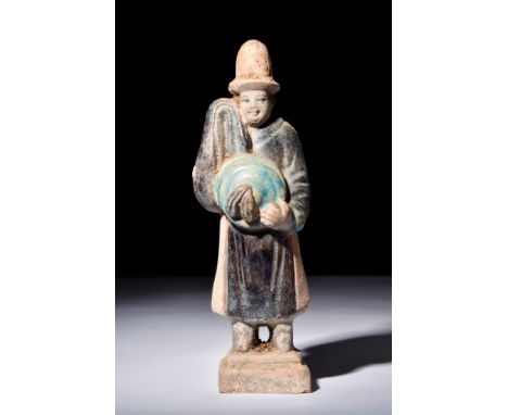 Ca. 1368-1644 AD.A glazed terracotta mingqi of a standing attendant in a dignified pose, dressed in a navy robe with red acce
