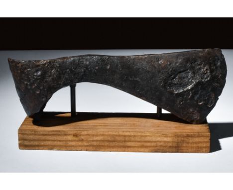 Ca. 900-1100 AD.An iron axe head with a narrow blade that flares toward a rounded cutting edge, allowing for precise and effe