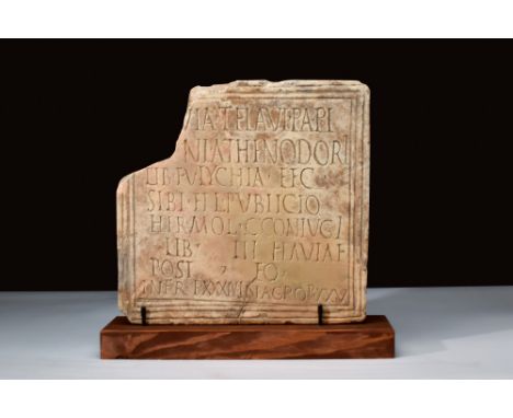 Ca. 200 AD.A Roman marble funerary plaque of rectangular form, carved within a plain grooved border and with eight lines of d