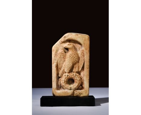 Ca. 100-200 AD.An ancient Roman stone plaque with a raised frame showing a grand eagle. The bird stands atop a laurel wreath 