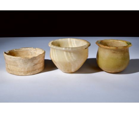 New Kingdom, Ca. 1550-1070 BC.A set of three ancient Egyptian alabaster vessels. Shallow round bowl and two bulbus shaped bow