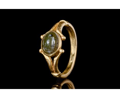 Ca. 100 AD.An oval-shaped green jasper intaglio of Faustulus leaning on his staff underneath a tree. The ring has a round hoo