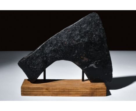 Ca. 900-1100 AD.An iron axe head featuring a sharp curved blade, ideal for swift slashing in battle. Its tapering cheek adds 