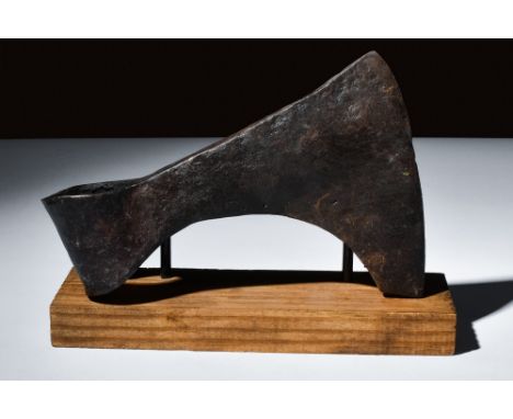 Ca. 900-1100 AD.An iron axe head with bearded design allowing for versatile cutting. It has a heavy end with an opening to at