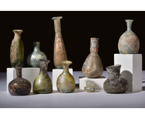 Ca. 100-300 AD.A set of 10 distinctly shaped glass vessels used to store perfumed oil, or unguents. The shapes in this lot va