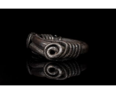 Ca. 900-1000 AD.A round silver finger ring formed from twisted silver rods. Other, more delicate, silver rods are also coiled