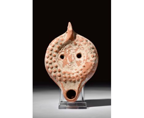 Ca. 200-300 AD.A pottery oil lamp with a rounded body, flat bottom, spout, and vent holes in the sunken discus. The lamp has 
