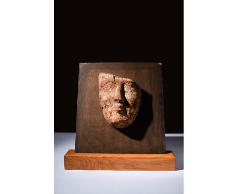 Late Dynastic Period, Ca. 664-32 BC.A carved wood mummy mask with expressive eyes, a broad nose, full lips, and detailed cont